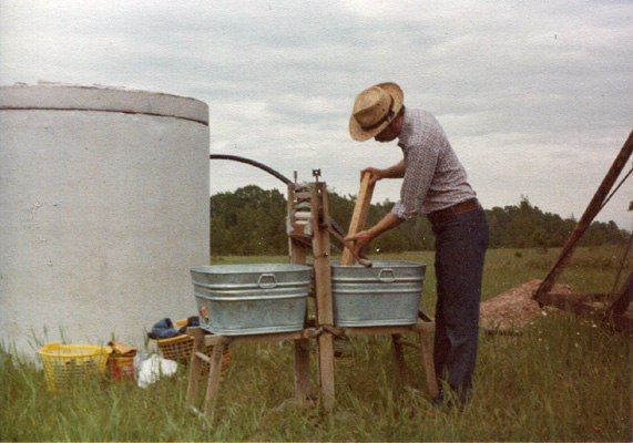 laundry by hand beside new water tank