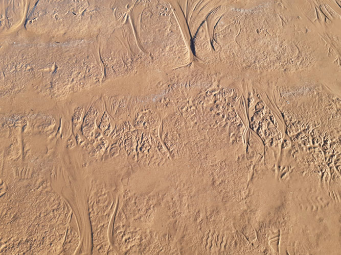snow melt patterns in sand at Thompson Beach