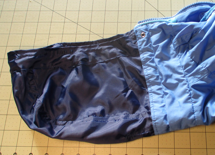 sewn nylon hood atttached to windbreaker